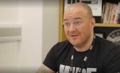 A man wearing a black t-shirt.