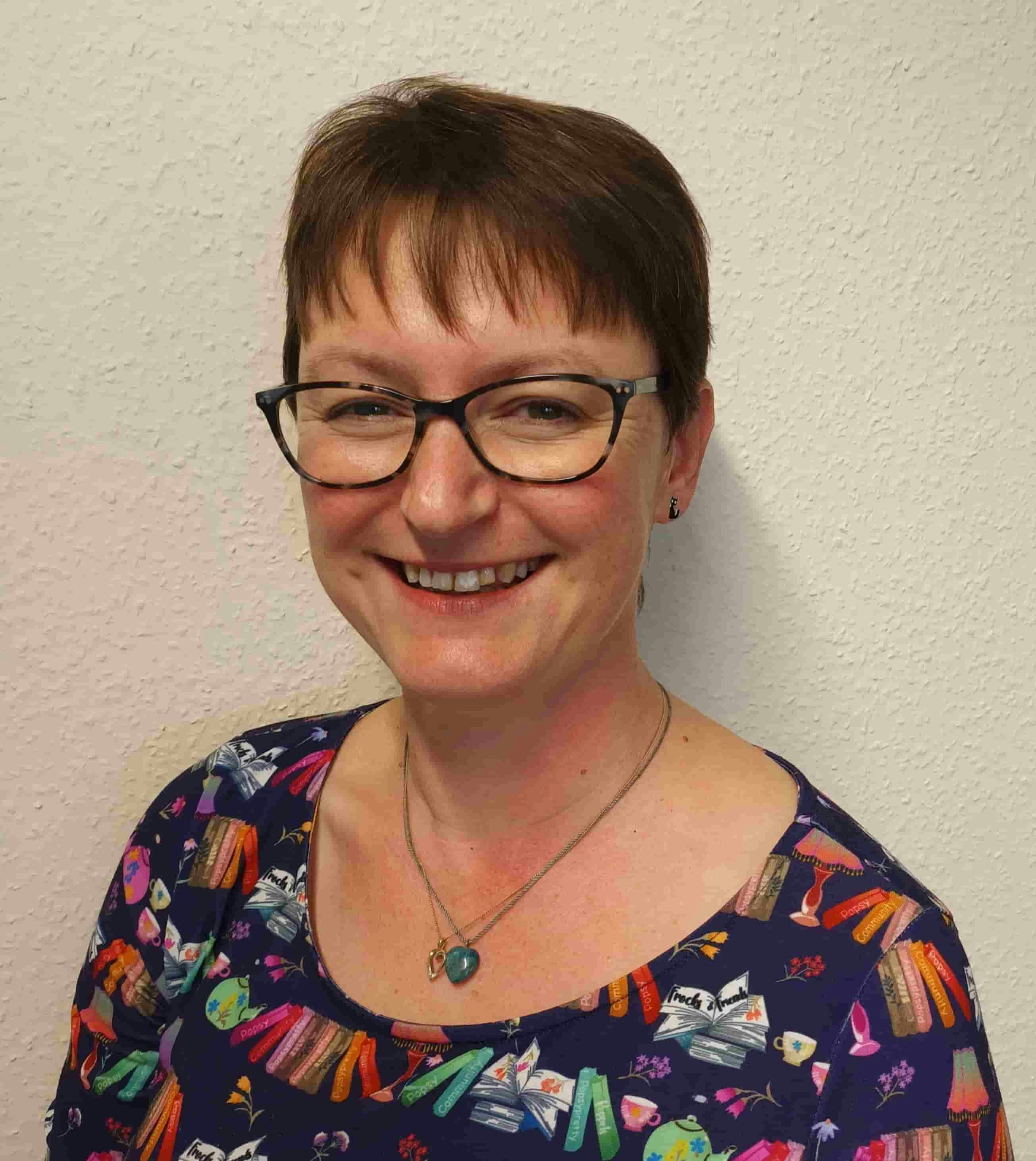 A smiling woman wearing glasses