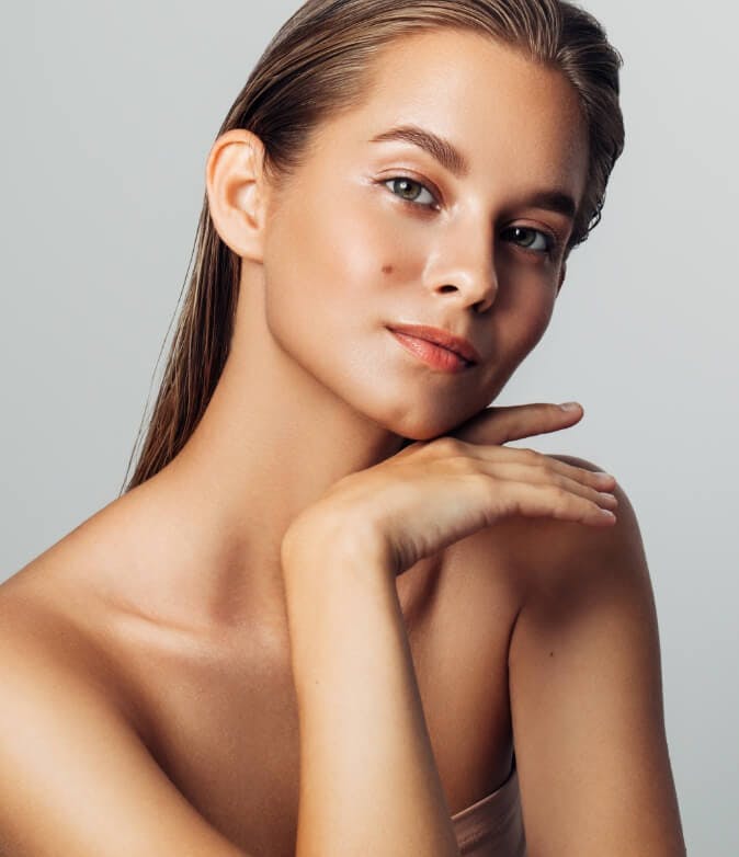Beautiful woman with clear skin resting her face on her hand