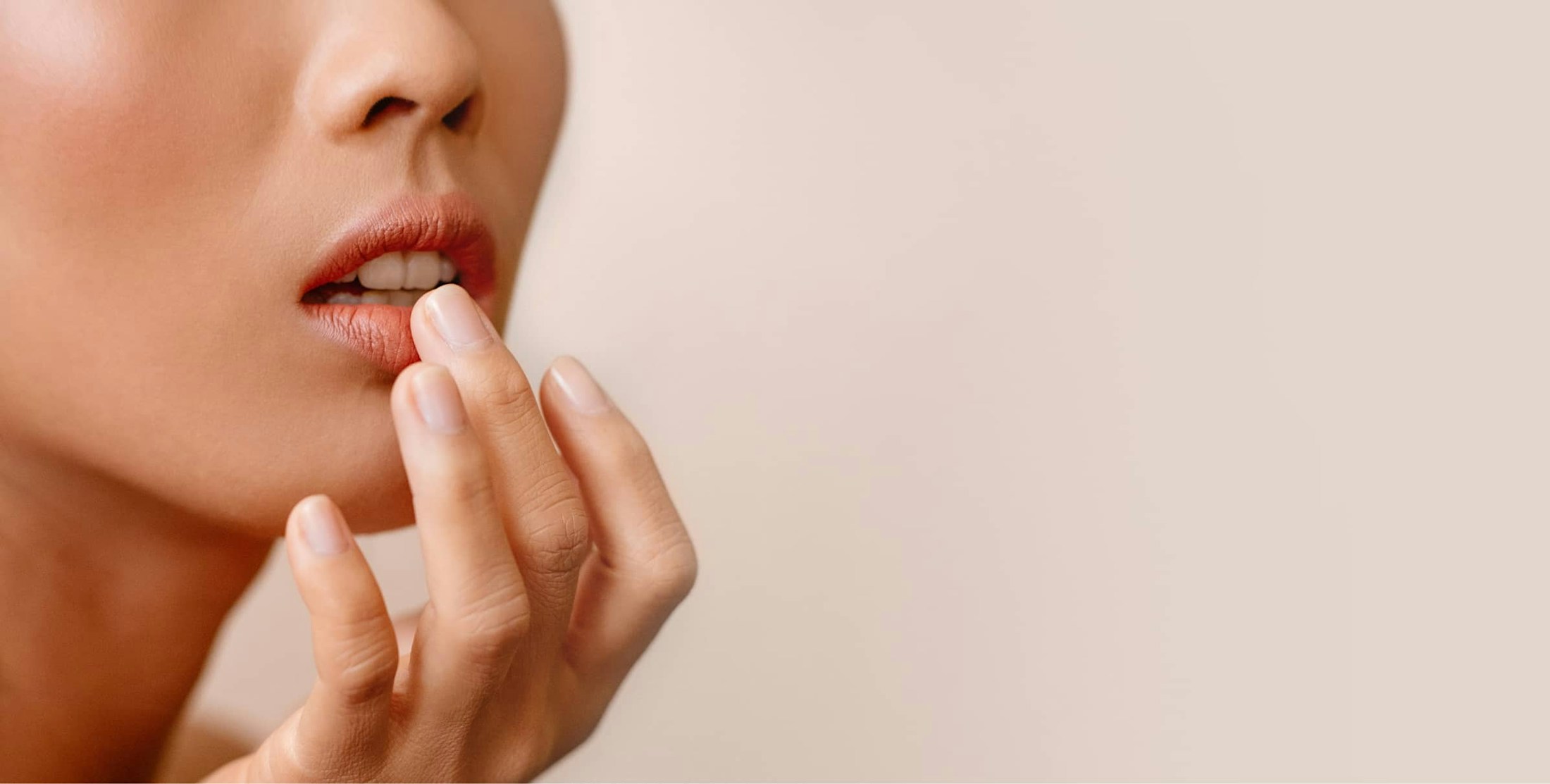 Close up image of woman touching her lips