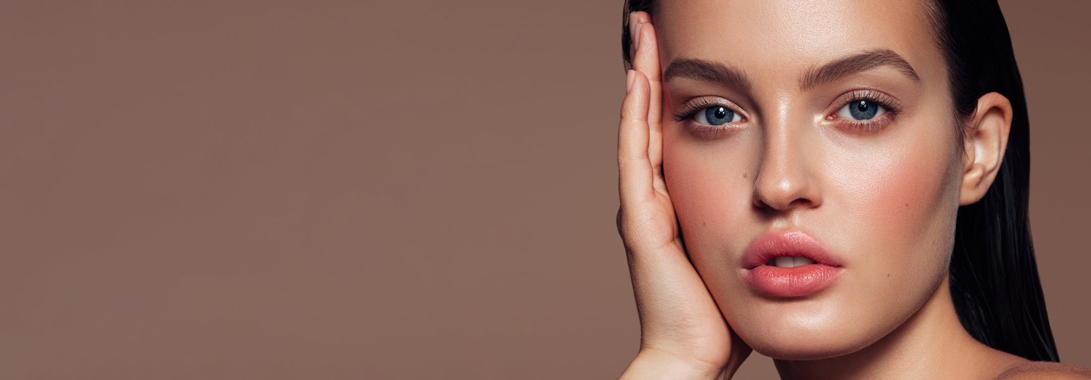 brunette woman touching face