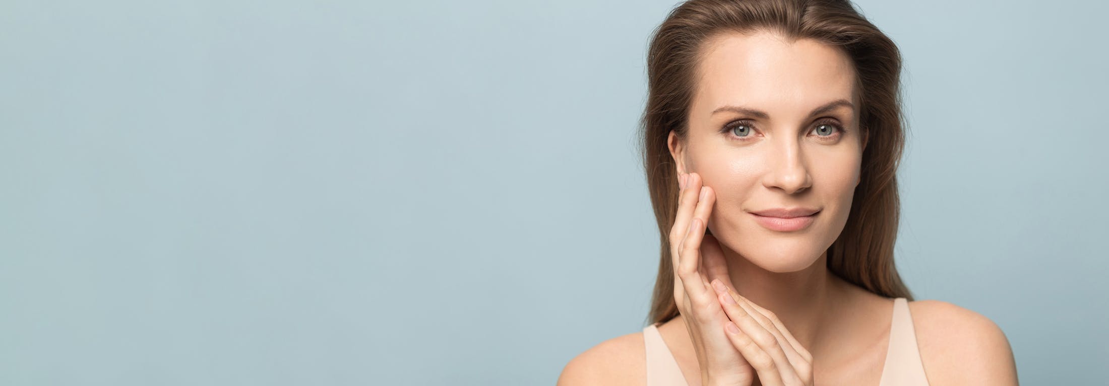 brunette woman touching face