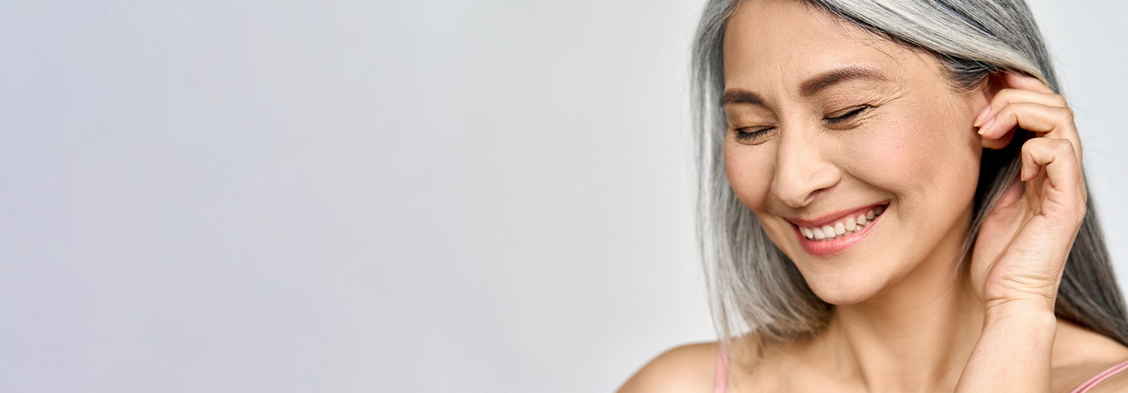 woman with grey hair laughing