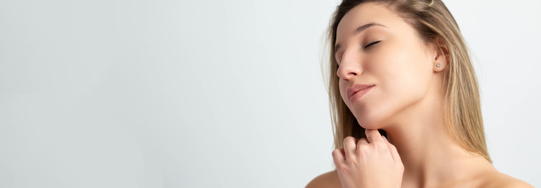 blonde woman touching chin