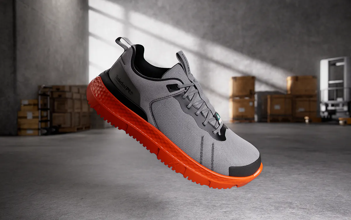 Gray shoe orange sole floating in a warehouse