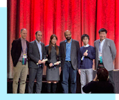 Newsletter Thumbnail for 2020-02. Researchers from AI2's MOSAIC team pose for a photo after winning the AAAI 2020 Outstanding Paper Award.
