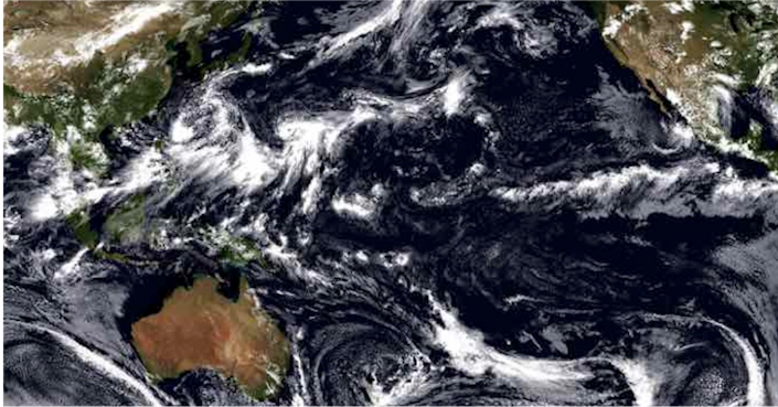 A photo of the pacific ocean from space, showing a number of cloud formations.