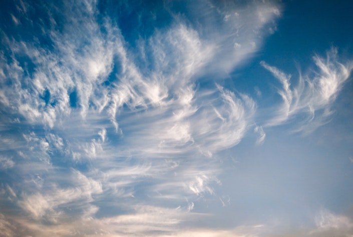 Wispy clouds in a blue sky.