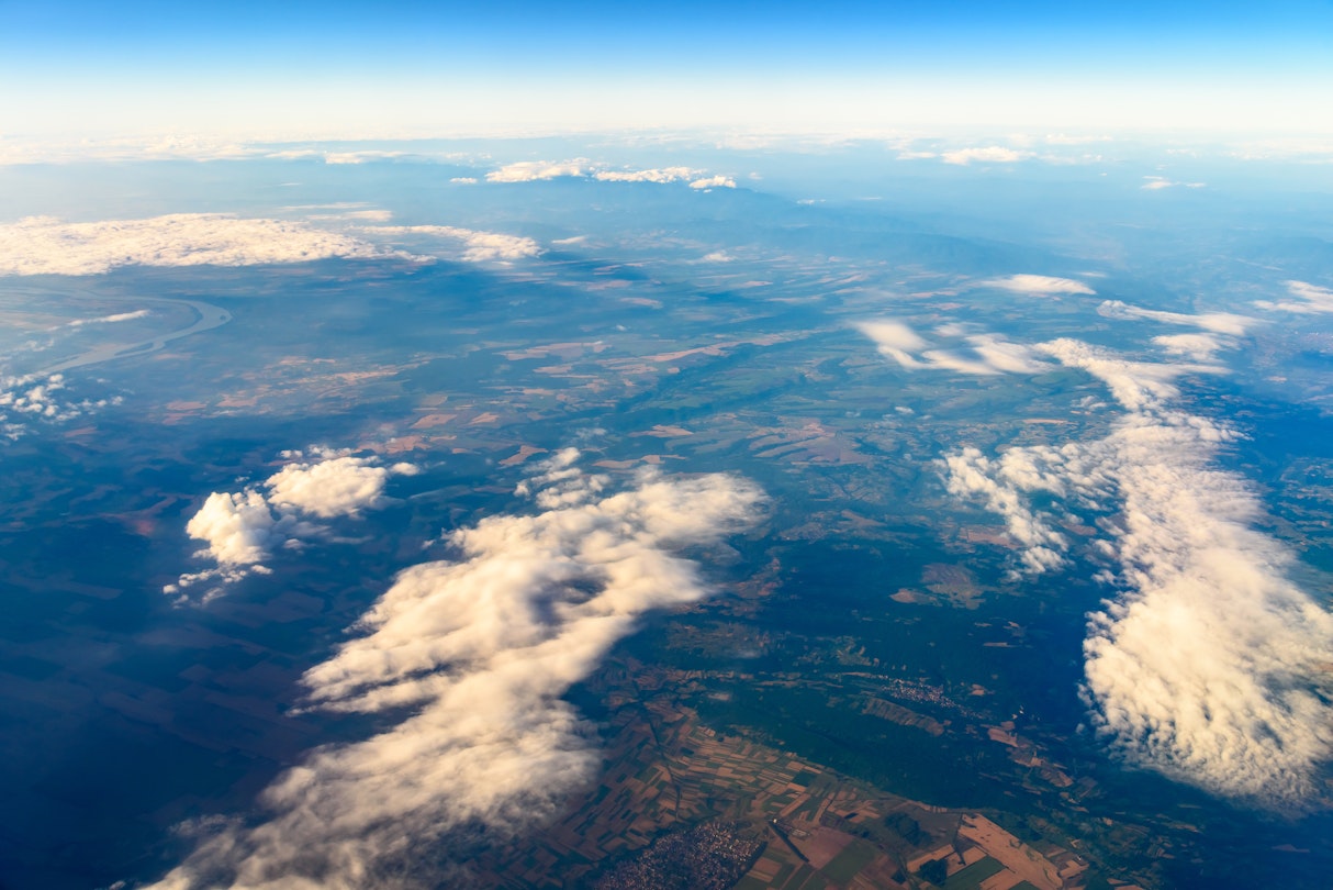 An aerial view with a mix of landscapes and a visible horizon