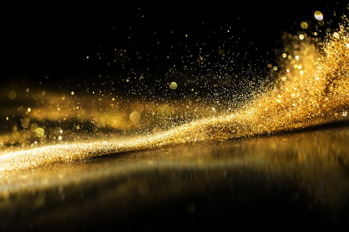 Glitter lights grunge background, gold glitter defocused abstract twinkly lights background.