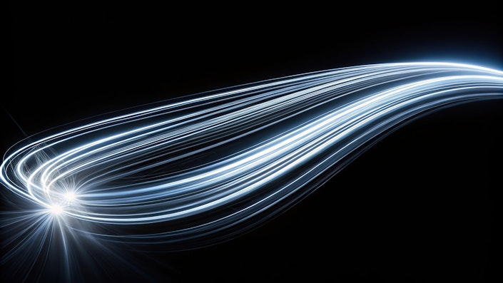 Glowing white light trails on a black background aerial view