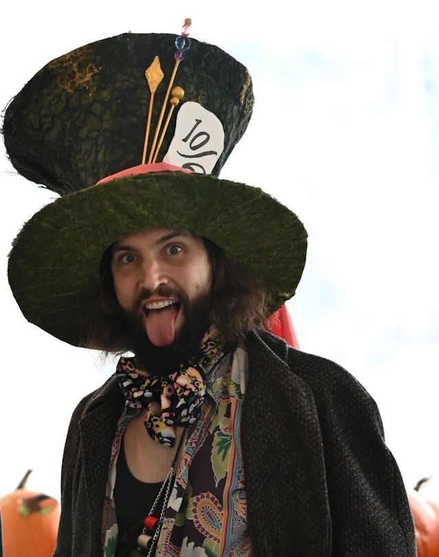 A man is dressed like the Mad Hatter from Alice in Wonderland.