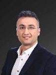 Özel dikim siyah takım elbiseli yakışıklı bir adam gri bir arka planın önünde kendinden emin bir şekilde duruyor. Kısa, koyu renk saçları ve hafif bir sakalı var ve gözleri uzaklara bakıyor. Duruşu rahat, elleri rahatça ceplerinde ve dudaklarında hafif bir gülümseme var. Zarif ve sofistike görünüyor ve hayatın sunacağı her şeyi üstlenmeye hazır. Beyaz gömleği ve siyah kravatıyla kıyafetini tamamlıyor ve görünümüne sofistike bir hava katıyor.