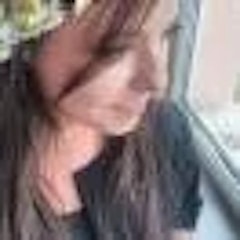 Bu, bir pencerenin önünde duran bir kadının görüntüsüdür. Ellerini önünde kavuşturmuş ve yüzü pencerenin yansıması tarafından kısmen gizlenmiş. İfadesi uzak ve düşünceli, sanki uzaktaki bir şeye bakıyormuş gibi. Beyaz bir elbise giymiş ve siyah saçlarını arkaya toplamış. Pencereden gelen ışık yüzüne yumuşak, bulanık bir parlaklık veriyor. Düşünceler içinde kaybolmuş gibi görünüyor, bakışları çerçevenin dışındaki bir şeye odaklanmış. Görüntü bulanık olmasına rağmen, kadının duyguları hala belirgin ve sahne bir özlem ve tefekkür duygusuyla dolu.