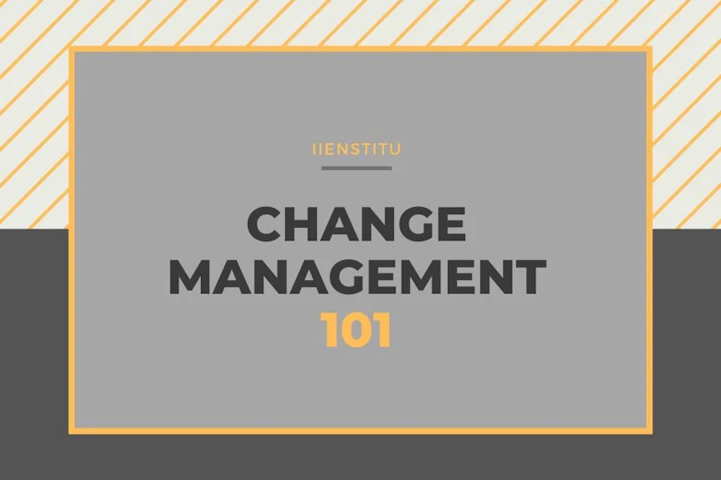 This is an image of a grey rectangular sign with black text. The sign is situated on a yellow and white striped roof, and has a grey and black logo at the bottom. The text on the sign is black and has a grey background. It appears to be some kind of numbers written in a bold font. There are various black letters on the grey background, with one located at the top, one at the bottom, and one in the middle. The lettering is sharp and stands out against the grey. The sign looks like it is made out of metal and is quite large. The overall image could be used to represent an industrial or urban environment.