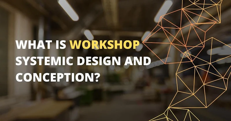 This close-up image shows a workshop, with a logo in the background on the right side. The logo is a white text on a black background, and there is a light on the ceiling as well. There is also a yellow letter on a black background in the lower middle of the image. In the foreground, there is a triangle in focus, and a blurry image of a person's hand just to the left. The room has a window and a sign in the background, and the overall image is slightly out of focus.