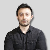 A man stands in front of the camera, wearing a black t-shirt and dark hair. His expression is serious and his posture is confident. His eyes are focused on the camera, and his arms are at his sides. He has a strong, muscular build, and his black t-shirt contrasts against his pale skin. His dark hair is styled in a short, neat cut, and it frames his face nicely. He looks determined, and his determined expression makes him stand out. He looks ready to take on whatever comes his way.