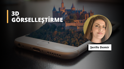 Bir kale resmi içeren bir akıllı telefonun yakın çekim görüntüsü görülüyor. Kale siyah bir arka plan üzerine boyanmış ve resmin ortasında bir kadın yüzü görülüyor. Kadının yüzünde geniş bir gülümseme var. Telefonun yanında bir masanın üzerinde beyaz bir tabak vardır. Kalenin arka planında ağaçlar görülebilmektedir. Resim canlı mavi bir gökyüzüne karşı yerleştirilmiştir. Telefon resmin ön planında, kale ise arka planda yer alıyor. Telefon, merkezinde kale görüntüsü bulunan net bir ekrana sahiptir. Kale, ayrıntılı ağaçlar ve yemyeşil bir manzara ile çevrilidir. Görüntü net ve resmin renkleri canlı. Kadının yüzü merkezde net bir şekilde görülebiliyor ve gülümsemesi sıcak ve davetkar.