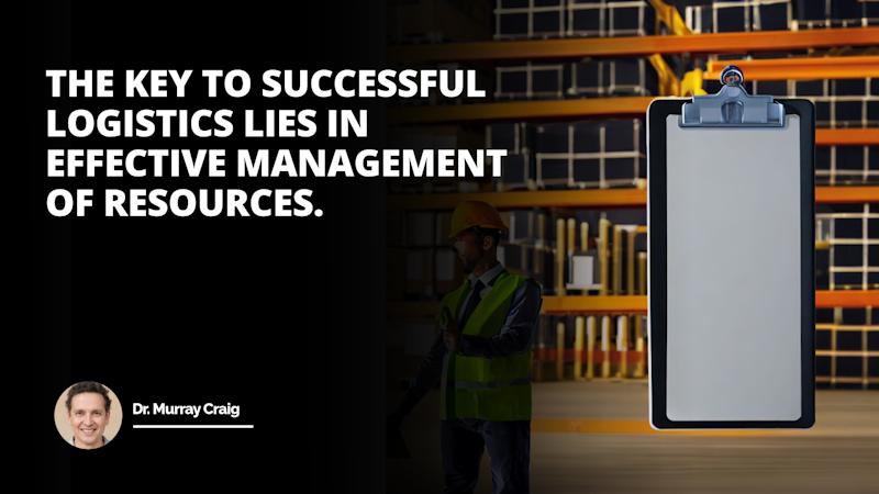 A man wearing a bright yellow safety vest and black helmet stands next to a clipboard. He has a cheerful expression on his face and is holding a tablet computer in his hands. The yellow of his helmet stands out against the black screws on it. In the background, there is a black backdrop with white text, including a white letter 'O' on it. The man is in sharp focus, while the person wearing the blue helmet in the background is slightly blurred.