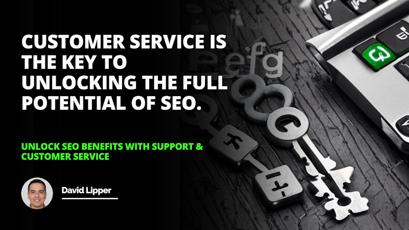 This image shows a close-up of a metal key sitting on a wooden table. The key has a gold finish and a number etched into one side. In the background, there is a white letter 'O' on a black background, and a white letter on a black background. Additionally, there is a green button with white text and a square object in the lower right corner. A man wearing glasses is smiling in the lower left corner. Everything in the image has sharp, crisp details. The light reflects off the key and the metal creates an interesting contrast with the wooden table.