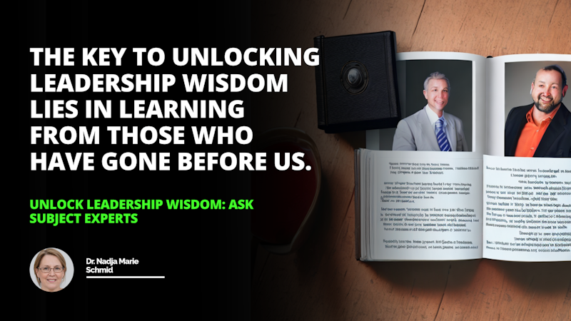 A man is sitting at a desk, holding a book in his hands. He is wearing a black suit and a tie, with a white letter O on the lapel. His eyes are closed as he reads the book. He has glasses on and a slight smile on his face. Behind him, a black rectangular object with a round circle in the middle can be seen. On the side, a close-up of a tie can be seen. There is also a screenshot of a phone on the far right corner of the image. The man is surrounded by a warm light, and the background is a neutral gray color. All in all, the man looks content and focused on the book he is holding. He looks intelligent and serious, and the image conveys a feeling of peace and tranquility.