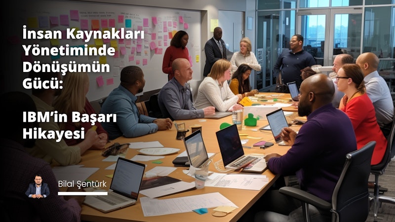 Bir grup insan, her biri kendi dizüstü bilgisayarıyla bir masanın etrafında toplanmıştır. Bir adam önünde açık bir dizüstü bilgisayarla masada oturuyor ve yanındaki masada da bir dizüstü bilgisayar var. Masanın üzerinde yeşil bir nesne de var. Adamın sağındaki masada bir kadın oturuyor ve önünde bir dizüstü bilgisayar var. Kadının solunda bir başka dizüstü bilgisayar sehpanın üzerinde durmaktadır. Herkes işine odaklanmış ve dalmış görünüyor.