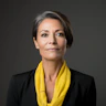 An older woman in a black suit and yellow scarf, in the style of contemporary portrait photography, danish design, uhd image, sterling silver highlights, colorful portraiture, fine line details, light gray