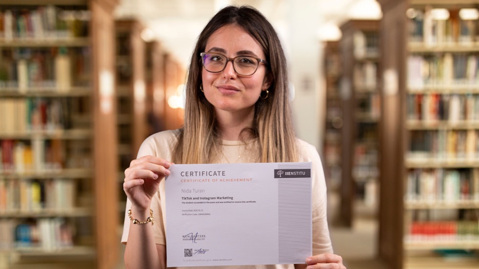 A woman certified in stress management displays her certificate in the library. She bought a certificate that says stress management. Professional certificate.