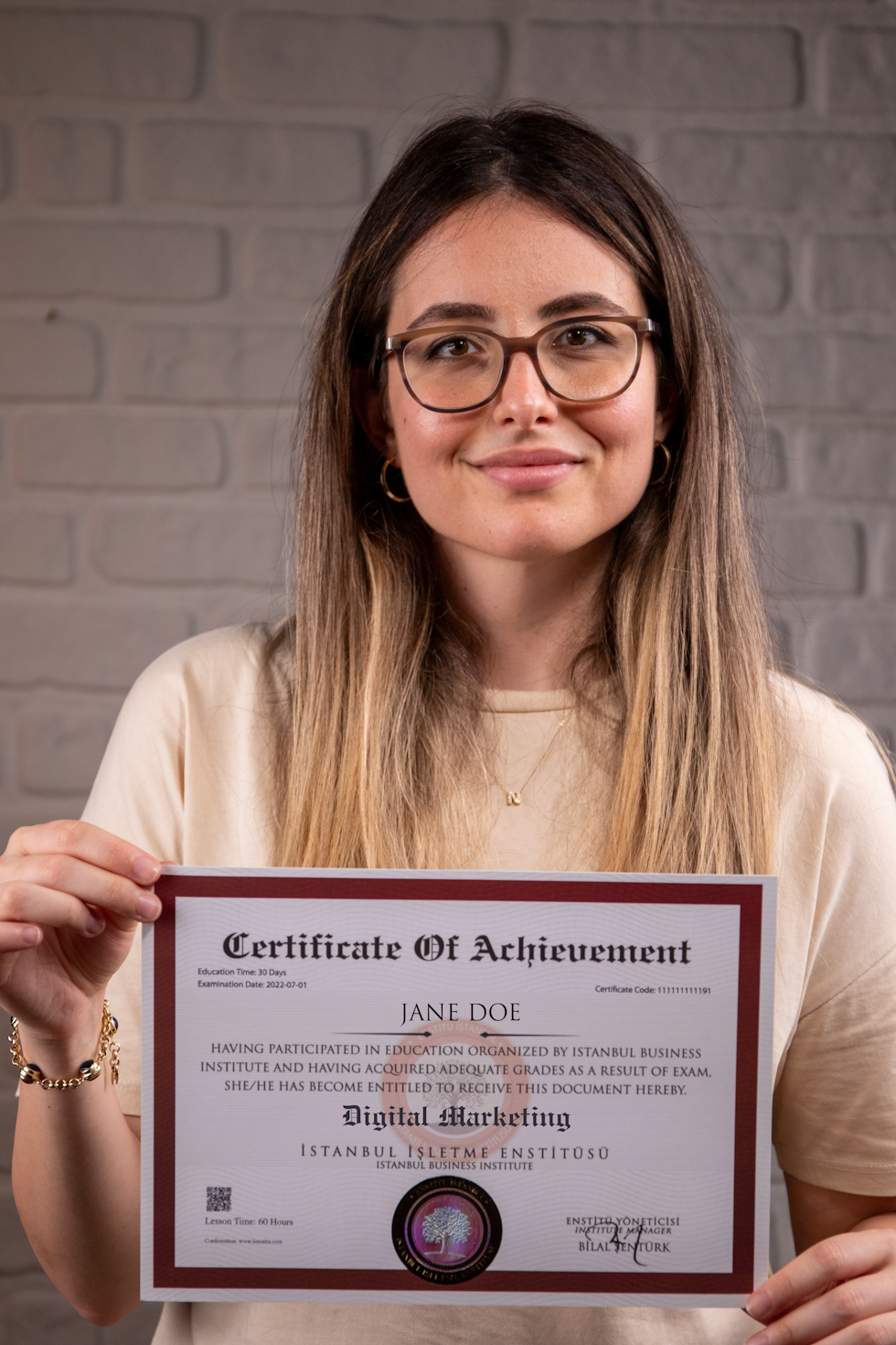 A woman holding a digital marketing certificate. The background is a stone wall. There is a diploma, a certificate from the university.