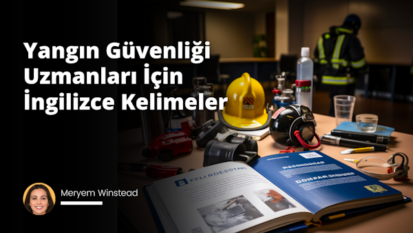Resim, geniş bir masanın üzerinde açık bir kitabın merkezinde durduğunu gösteriyor. Kitabın sayfalarında, İngilizce yangın güvenliği ile ilgili teknik terimler ve tanımlar yer alıyor. Kitapta göze çarpan başlıklardan birkaçı 'Fire Extinguisher', 'Evacuation Plan' ve 'Smoke Detectors'. Kitabın hemen yanında, bir yangın güvenliği uzmanının koyu mavi üniforması ve bir teçhizat kemeri görülmekte. Kitabın diğer yanında ise bir not defteri ve bir kalem duruyor; bu da uzmanın not alabileceği anlamını taşıyor. Arkada çok hafif görünen, ancak yine de belirgin olan arka plana rağmen kitap, üniforma ve not defteri resmin odak noktası. Resim, yangın güvenliği uzmanlarının okuması ve anlaması için bir referans kitabı anlamını taşıyor.