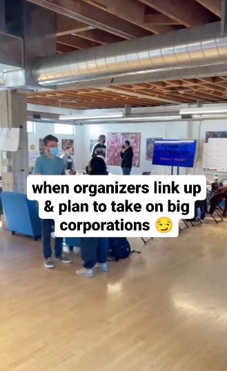 Still from a video of our PowerUp training, text on screen reads: "when organizers link up & plan to take on big corporations"