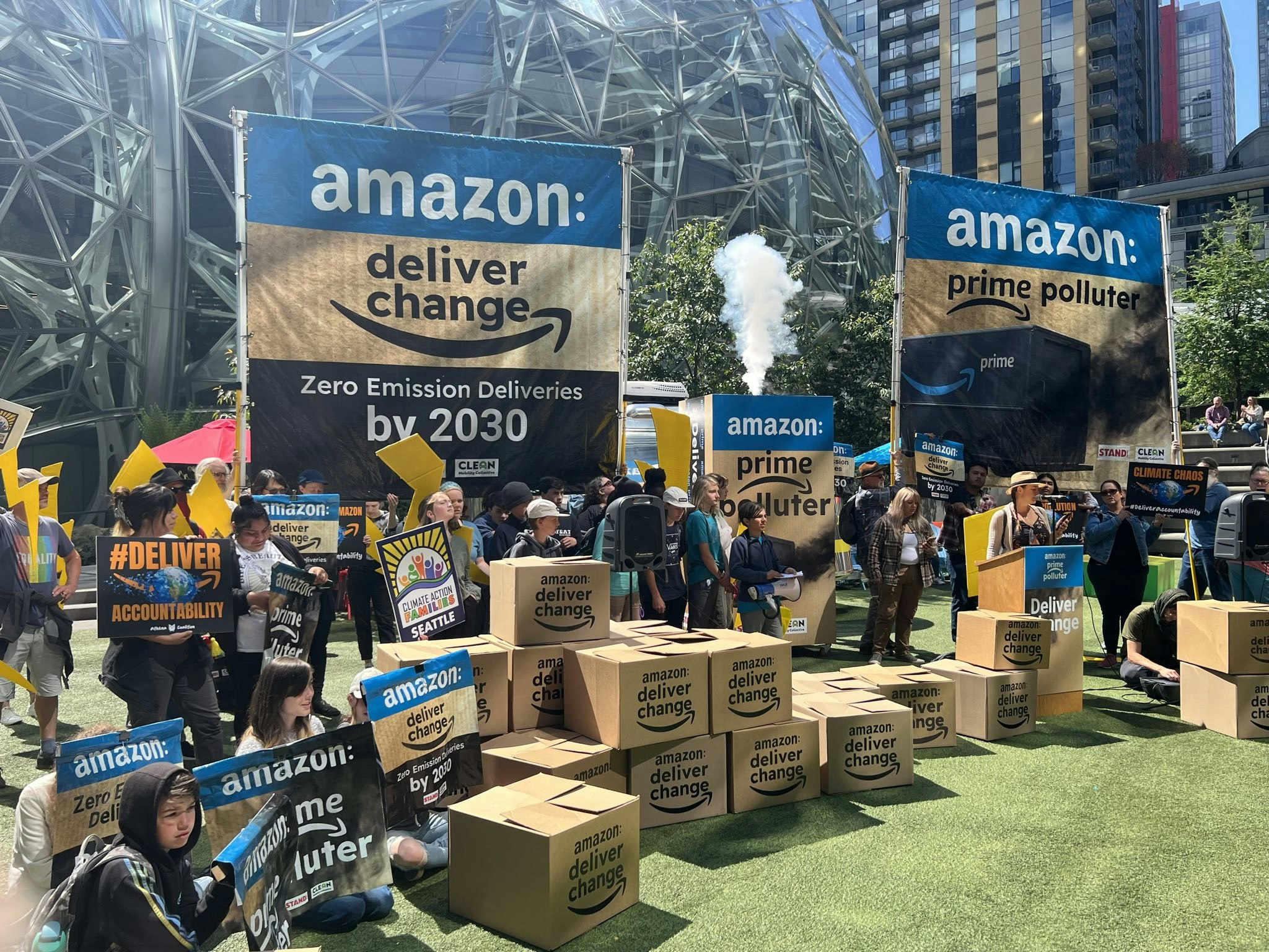 Amazon workers, Athena coalition, and allies rally at Amazon's Seattle HQ holding signs demand climate action and accountability.