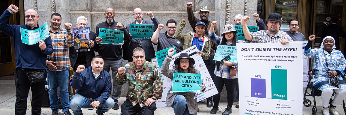Uber drivers with Chicago Gig Alliance at a press conference with signs reading "don't believe the hype"
