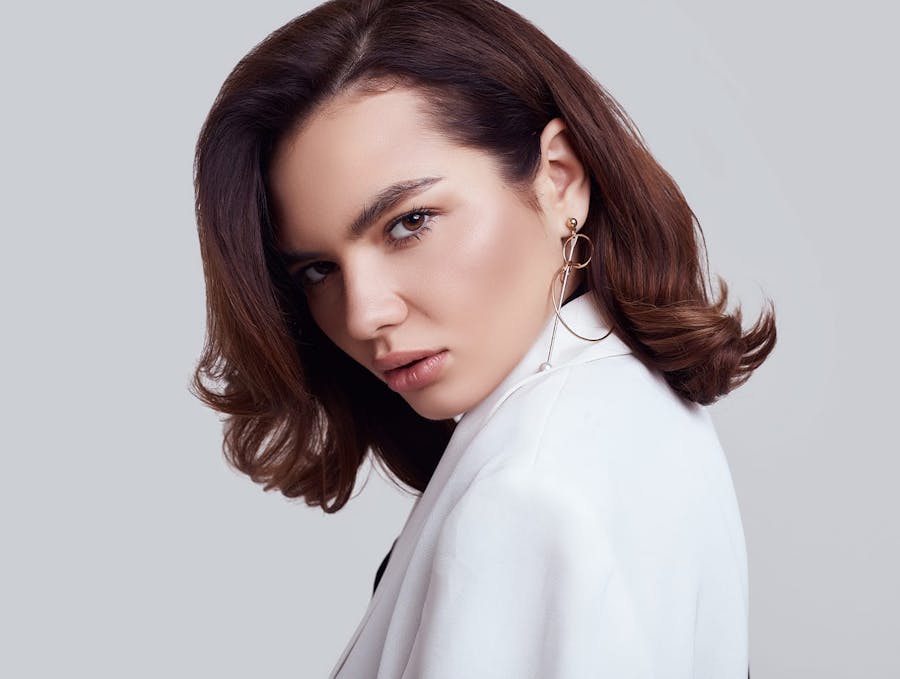 woman with brunette hair tucked behind ear