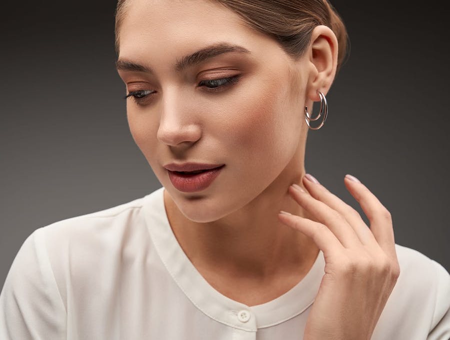 woman with hair up and hoop earrings