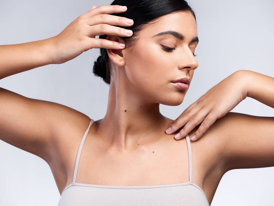 woman touching face and shoulder