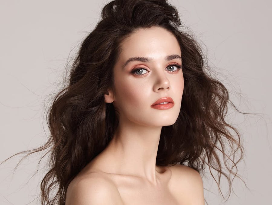 woman with curly hair and exposed shoulders