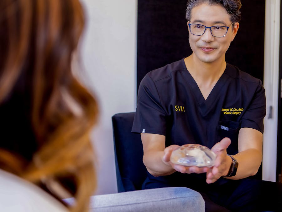 Dr. Liu holding a breast implant