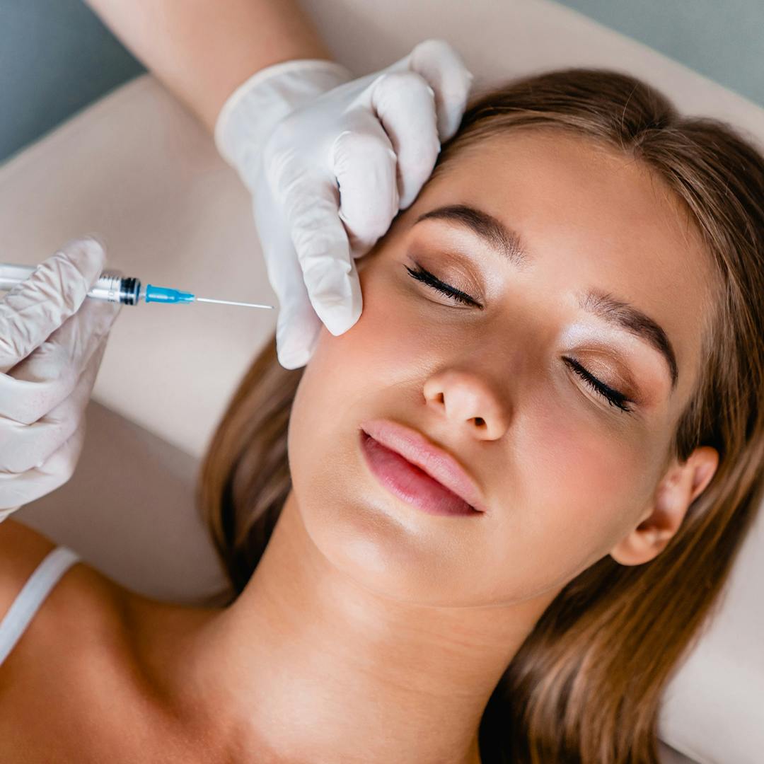 Pretty blonde woman receiving facial injectables.