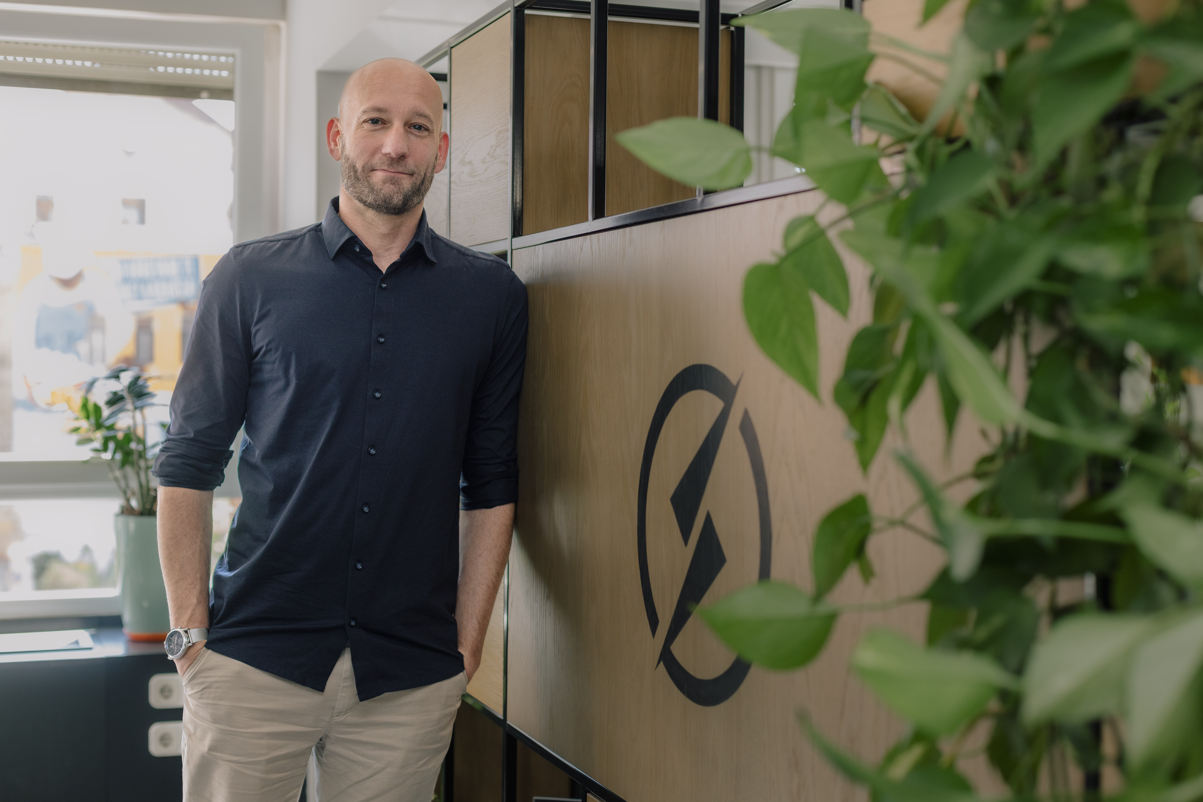 Nils Teipel Energy Director standing next to Supercharge logo