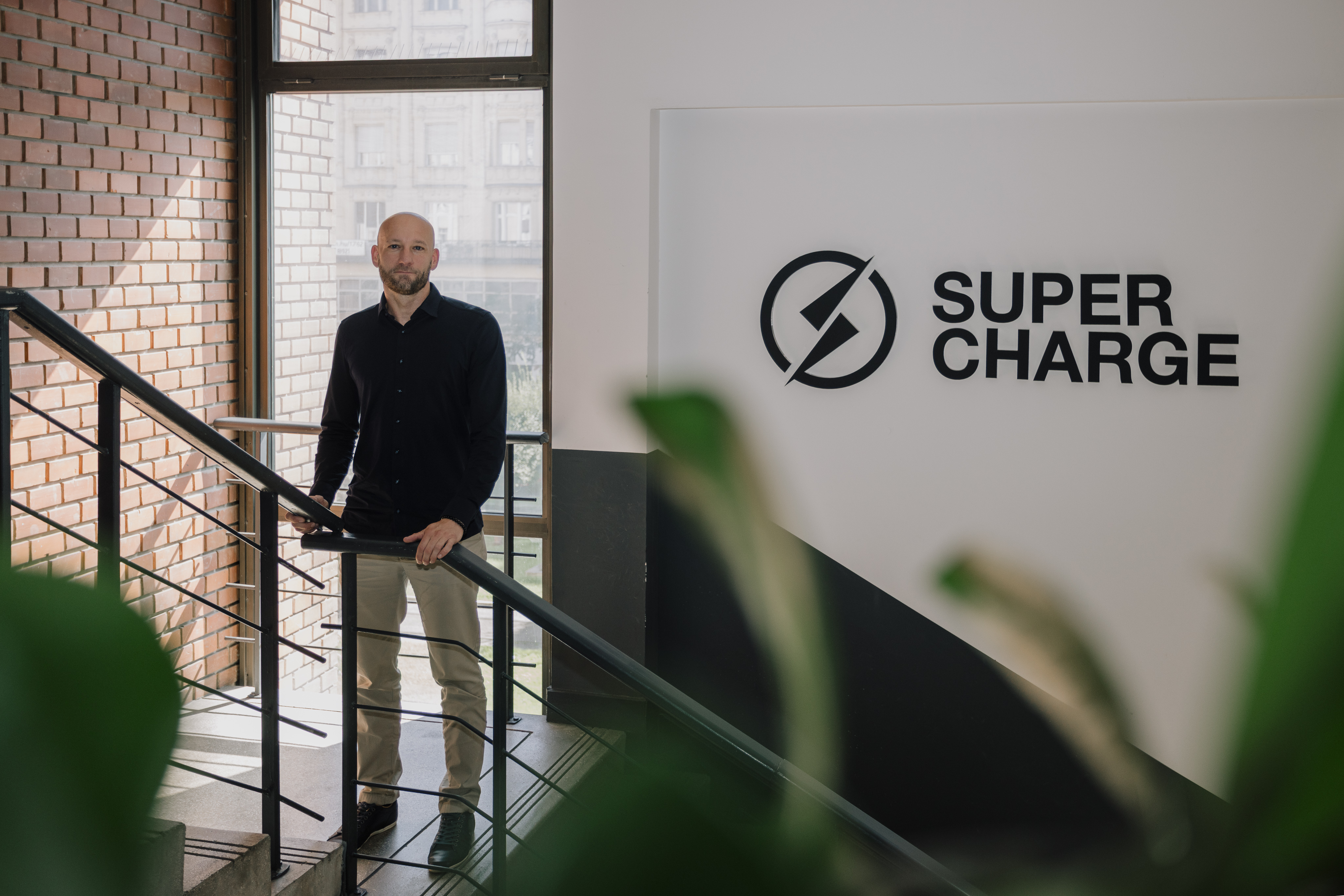 nils standing in front of supercharge logo