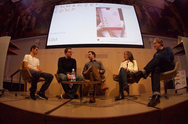 5 people sitting on a stage