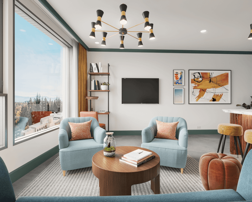 Living room setting with chairs, a chandelier, a bookshelf, and art on the walls next to a large window.