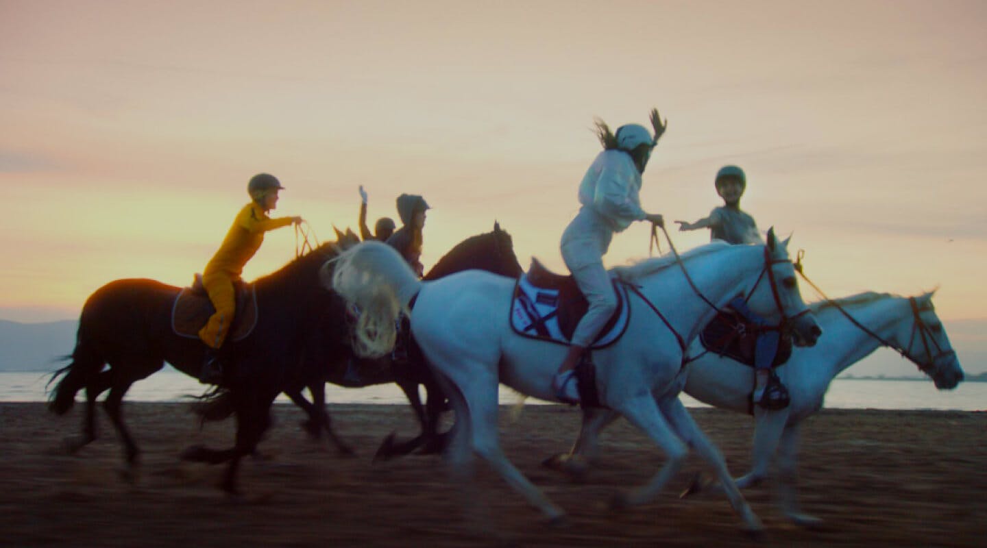 Girls riding on the beach