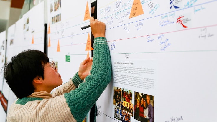 A conference attendee writes on a comments wall