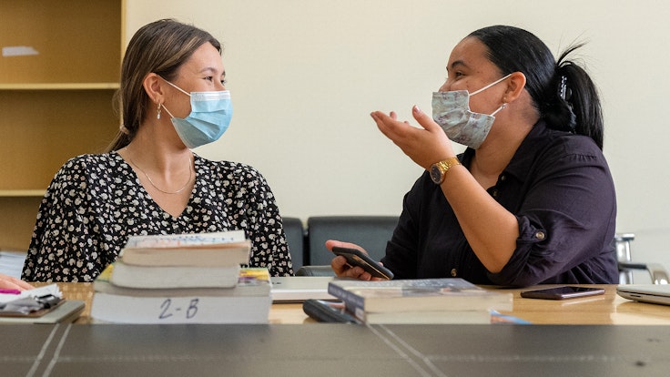 Two members of school staff engaged in lively conversation