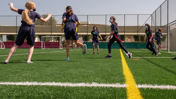 WellSpring girls playing football on an outside pitch