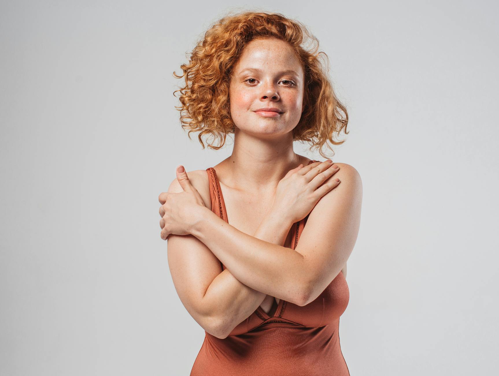 Woman with her hands on her shoulders