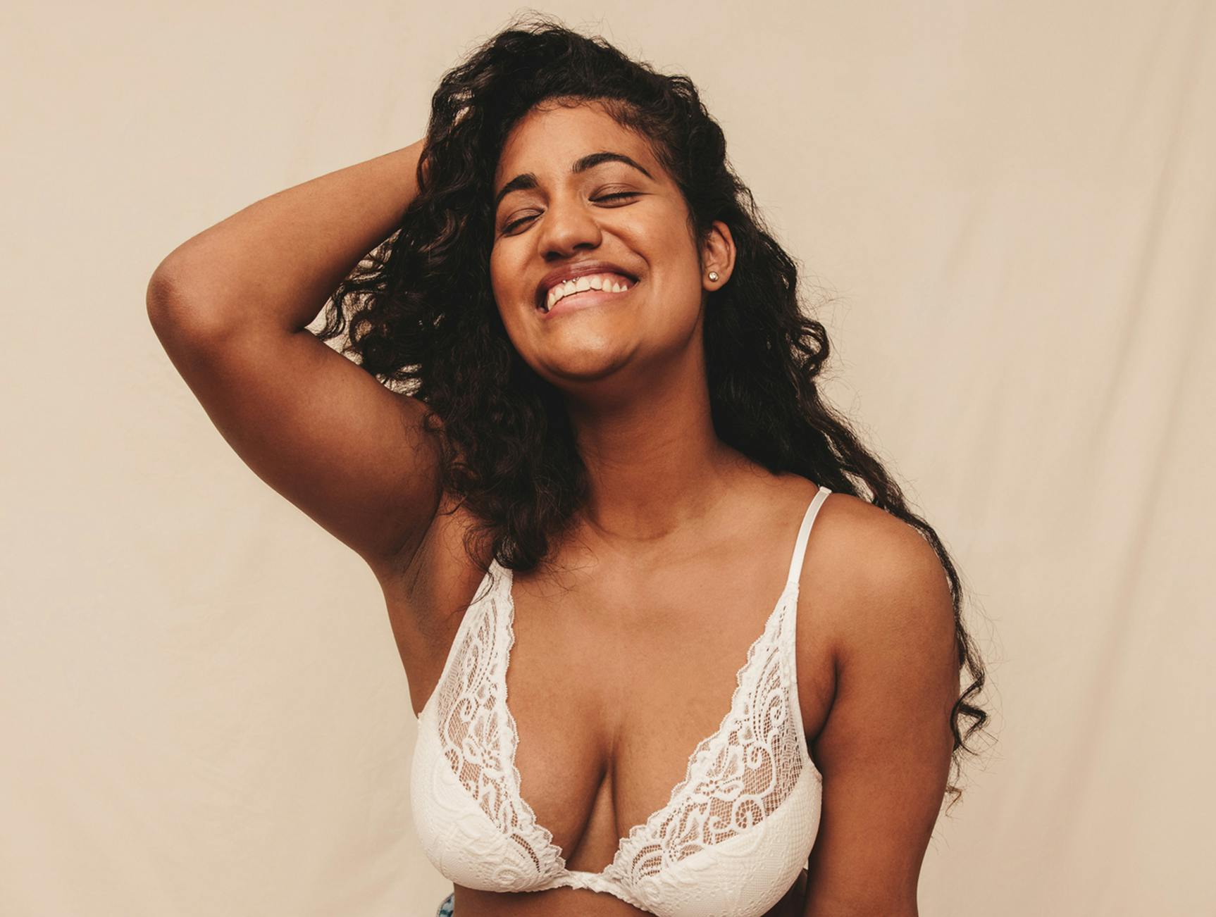 Woman wearing a white lace bralette