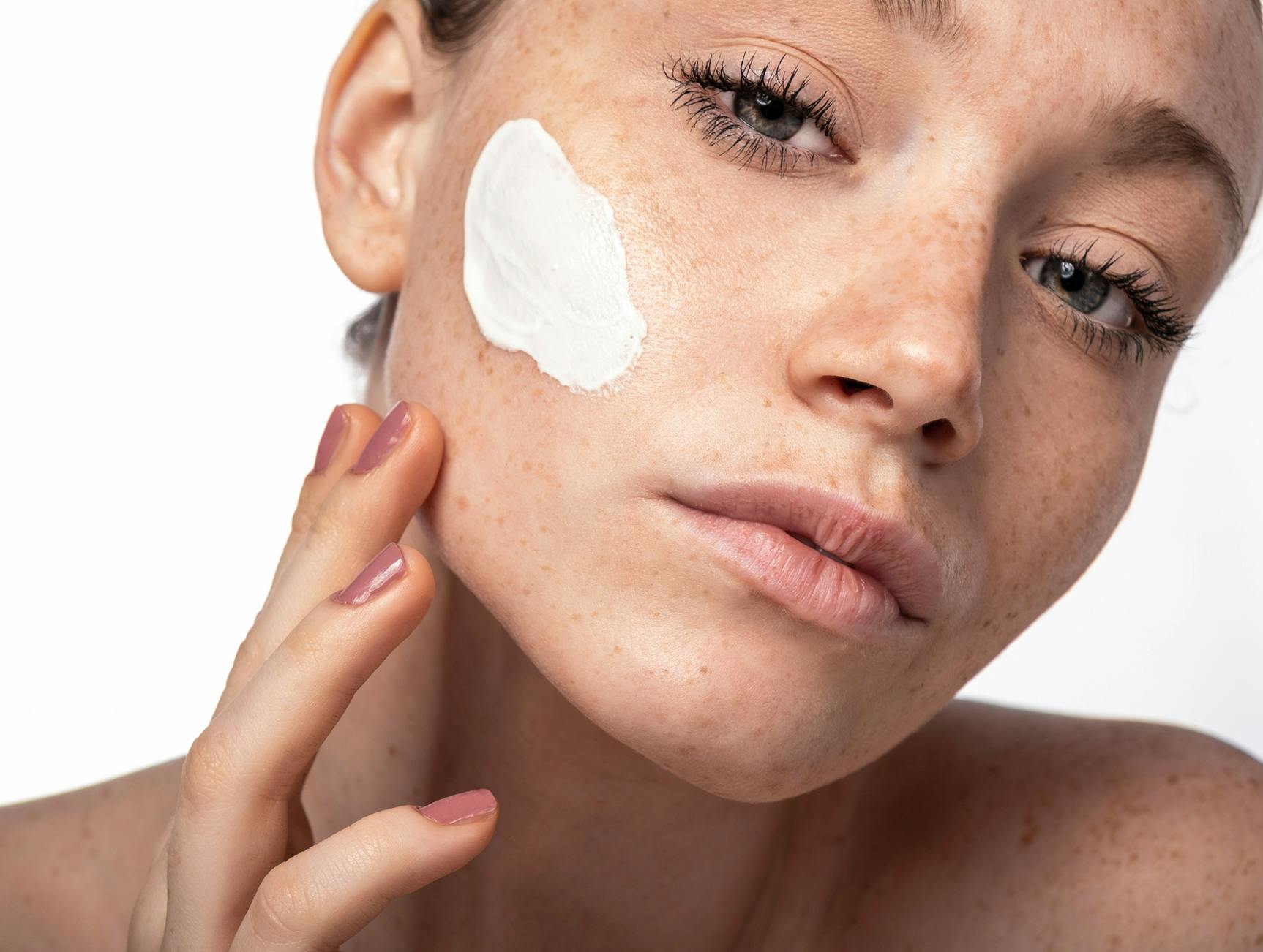 Woman applying skincare product